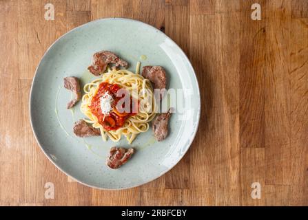 Savour the richness of our Spaghetti with tomato and mushroom sauce—a delightful harmony of tangy tomatoes, earthy mushrooms, and perfectly cooked pasta Stock Photo