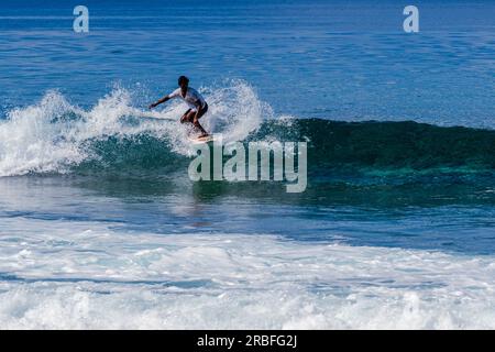 Malé Maldives--April 8 2023. A man and a woman stand in very shallow ...