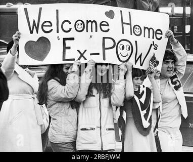 Fairfield, California:  February 14, 1973 Family members hold up a Valentine's Day greeting to released prisoners of war arriving at Travis Air Force Base. Stock Photo