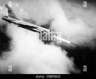 Vietnam:   November 22, 1965 A Navy Crusader jet from the USS Midway aircraft carrier fires a Zuni rocket at a Viet Cong target in South Vietnam. Stock Photo