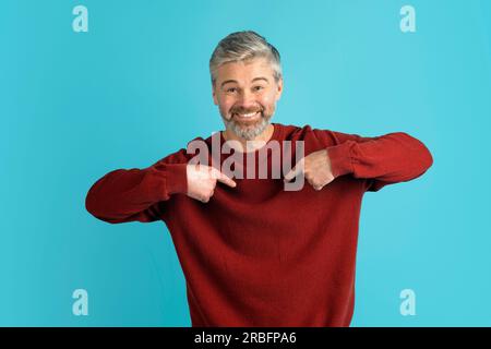 Cool middle aged man in casual outfit pointing at himself Stock Photo