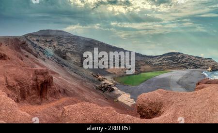 El Charco Verde or Charco de los Clicos, is a lagoon located next to the village of El Golfo, municipality of Yaiza, within the Timanfaya National Par Stock Photo