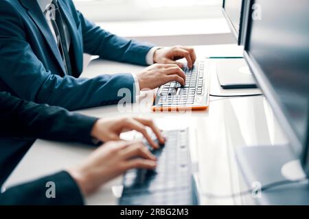 Business people working on laptop. People hands typing on laptop keyboard Stock Photo