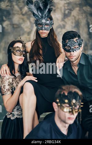 Group of people in masquerade carnival mask posing in studio. Beautiful  women and men wearing venetian mask. Fashion, party, friends concept Stock  Photo - Alamy