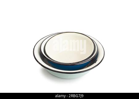 Pile of old enamel dishes, or bowls, isolated on white background Stock Photo
