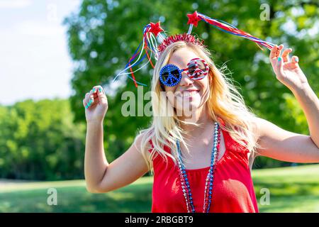 A patriotic blonde model having fun during the 4th of July holiday Stock Photo