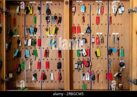 Multiple keys hang in a garage Stock Photo - Alamy