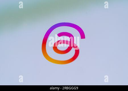Closeup on a smartphone screen showing the Instagram-like coloured logo for the Threads app, a new application for Instagram by Meta Stock Photo