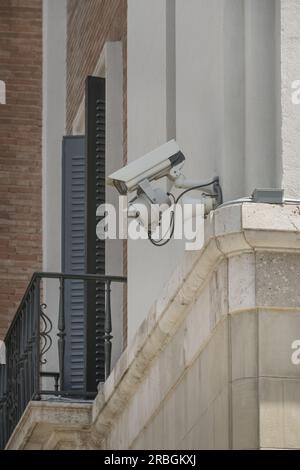 Surveillance cameras installed on the facade of a building on the corner Stock Photo