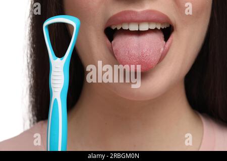 Woman with tongue cleaner on white background, closeup Stock Photo