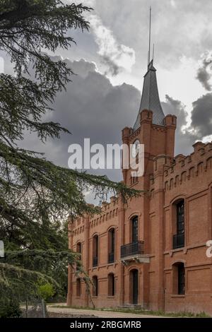 Main facade of an old building in a park with a dirt path Stock Photo