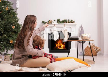 Mother and son watching movie via video projector at home Stock Photo