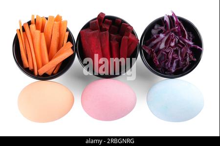 Naturally painted Easter eggs on white background, top view. Carrot, beetroot and red cabbage used for coloring Stock Photo