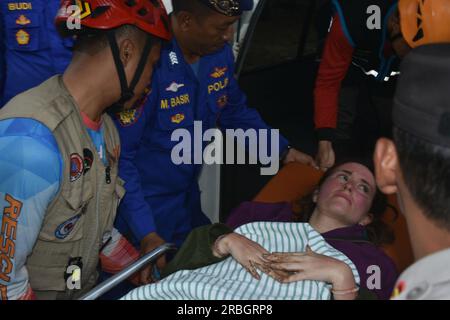 Malang, East Java, Indonesia. 9th July, 2023. 23-year old exchange student ANA BRIEVA RAMIREZ, from Spain, being taken to the hospital. She was found safe on Bantol Beach, more than 24 hours after a wave swept her and others into the ocean. Rescue teams are still searching for 24-year old Swiss student, Jana Olivia Soland. (Credit Image: © Aman Rochman/ZUMA Press Wire) EDITORIAL USAGE ONLY! Not for Commercial USAGE! Stock Photo