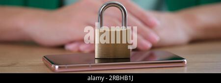 Closed metal padlock on smartphone, personal data security Stock Photo