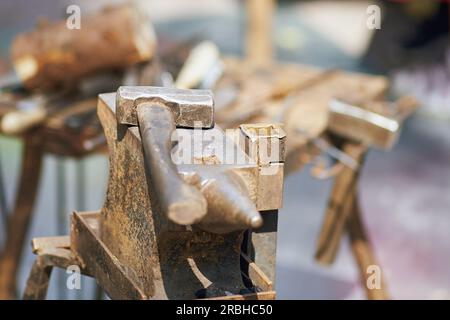 Hammer and tools for forging metal by a blacksmith. Blacksmithing in retro style outdoors Stock Photo