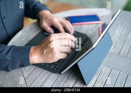 Businessman working on his tablet, close up view. Home environment. Stock Photo