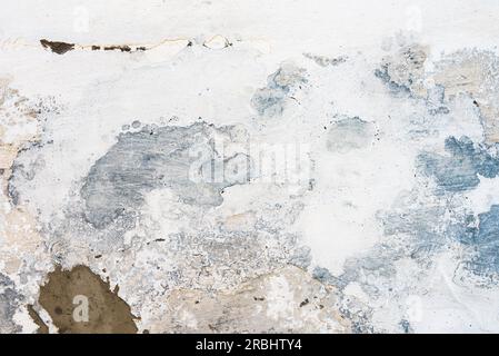 Texture of an old mud wall repaired with stucco and plaster as grunge background and copy space Stock Photo