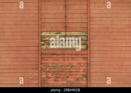 Old electrical light switch and cable on worn wooden shed exterior wall, copy space included Stock Photo