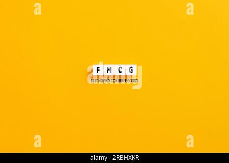 White letter blocks on yellow background with the acronym FMCG fast moving consumer goods. Stock Photo