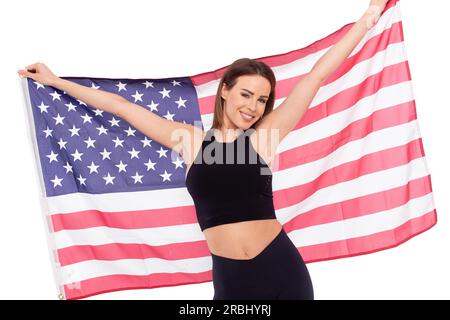 Young athlete Caucasian woman holding USA flag, isolated on white Stock Photo