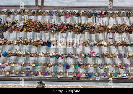 Romantic Paris. Love locks (padlocks) on Passerelle Leopold Serdar Senghor pedestrian bridge over River Seine. Stock Photo