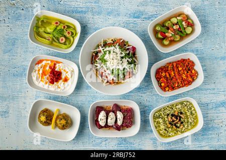 Different kinds of Turkish appetizers on white porcelain plates Stock Photo