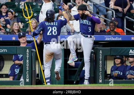 Seattle Mariners' Eugenio Suarez holds a trident as he celebrates