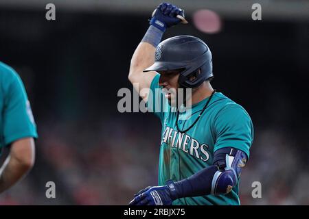 Seattle Mariners' Jose Caballero holds a trident in the dugout as teammates  dump sunflower seeds on his head as he celebrates hitting a three-run home  run against the Oakland Athletics in a