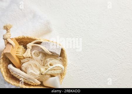 Wicker basket with set of cosmetic bottles, tubes, jars, brushes. Stock Photo