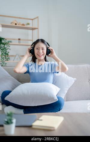 Peaceful girl in modern wireless headphones sit relax on