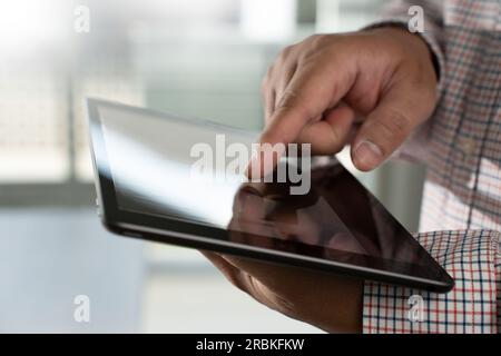 Man hands using looking and touch tablet laptop and cellphone communication mockup computer technology for tablet digital screen blank cyberspace onli Stock Photo