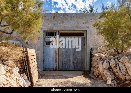 Old rusty iron gate in the stone wall Stock Photo