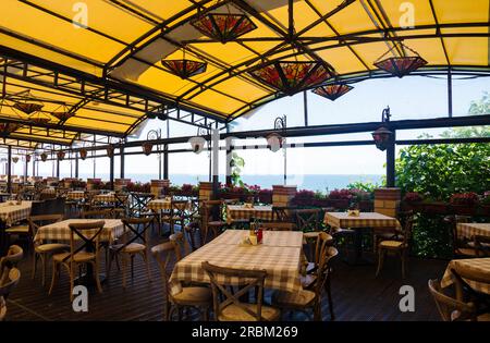 Beautiful cafe with flowers in Bulgaria. Outdoor restaurant, summer holidays Stock Photo