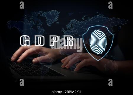 General Data Protection Regulation. Woman working with laptop on black background, closeup. GDPR abbreviation, shield with fingerprint and world map Stock Photo