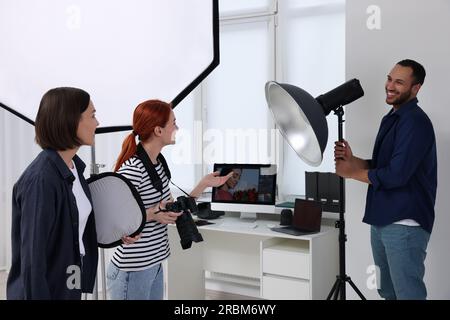 Young professional photographers working in modern photo studio Stock Photo