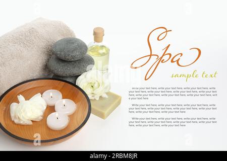Spa composition with bowl of water, flowers and burning candles on white background. Design with space for text Stock Photo