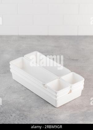 A set of plastic containers, boxes for convenient storage inside a drawer in the kitchen and at the desk. Stock Photo
