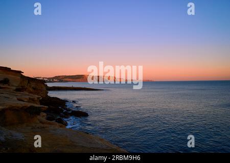 Sunset over the rocky coast on the Atlantic between Burgau and Luz west of Lagos, Algarve, Barlavento, Western Algarve, Rocky Algarve, Faro District, Stock Photo