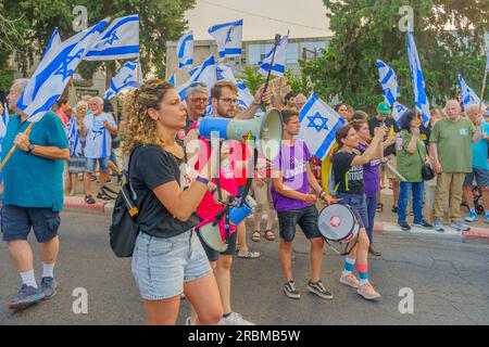 Haifa, Israel - July 08, 2023: People marching with flags and various signs. Week 27 of anti-government protest in Haifa, Israel Stock Photo