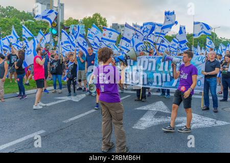 Haifa, Israel - July 08, 2023: People marching with flags and various signs. Week 27 of anti-government protest in Haifa, Israel Stock Photo