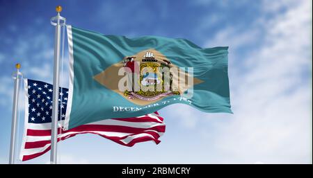 Delaware state flag waving in the wind with the National flag of the United States on a clear day. 3d illustration render. Fluttering fabric Stock Photo