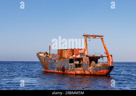 An abandoned old shipwreck in Walvis Bay near Walvis Bay on the coast of Namibia, Africa Stock Photo