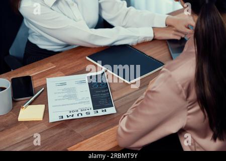 Closeup resume paper with qualifications on the desk during job interview  in the office with young applicant candidates and interviewer, discussing  on Stock Photo - Alamy