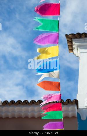 Facades of old and historic houses in Pelourinho decorated with colorful flags for the feast of Sao Joao in S Stock Photo