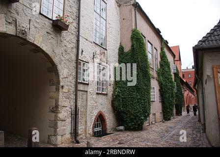 a narrow street amidst old stone buildings Stock Photo