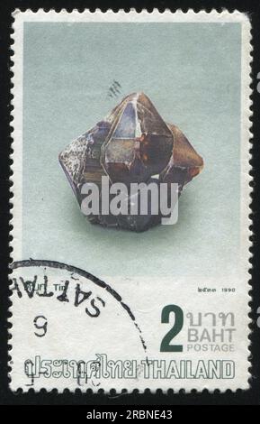 RUSSIA KALININGRAD, 31 MAY 2016: stamp printed by Thailand, shows piece of tin, circa 1990 Stock Photo