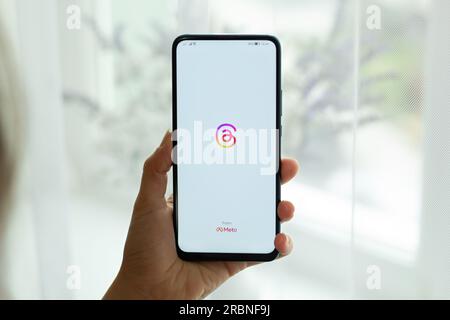 Kyiv, Ukraine - July. 8th, 2023: Threads logo on the phone screen in hand. Using the social network application. Stock Photo