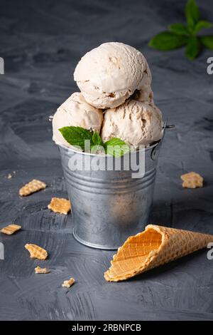 Vanilla ice cream with syrup in a metal bucket Stock Photo