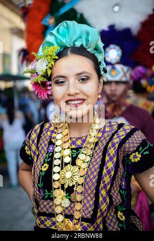 young woman in traditional costume smiling at the camera, city of Oaxaca de Juárez, Oaxaca State, Mexico, North America, Latin America Stock Photo